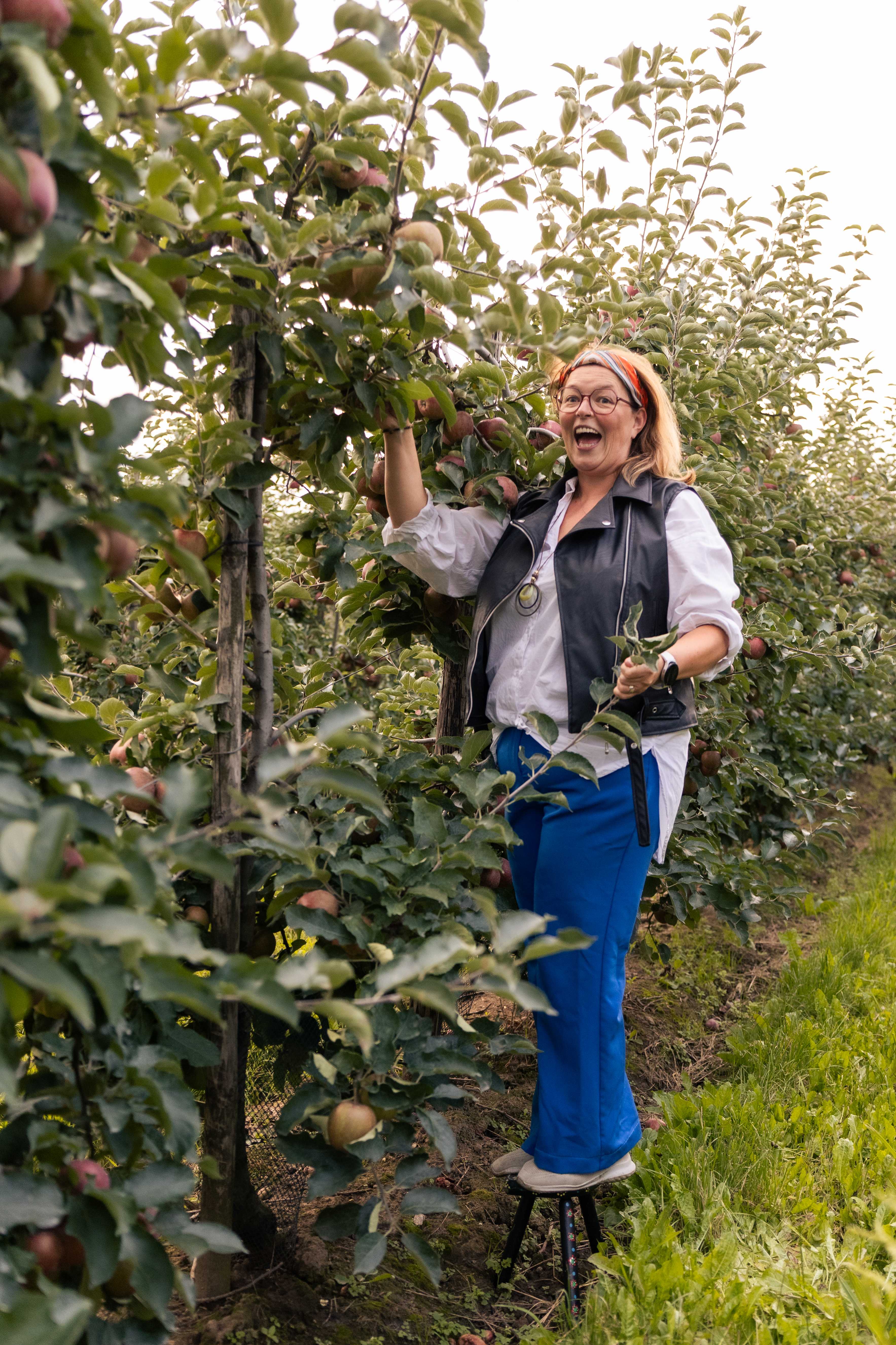 Isabel Bekhuis lachend in de appelboomgaard